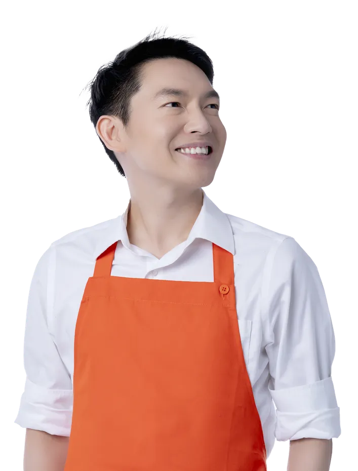 Smiling restaurant team member in an orange apron